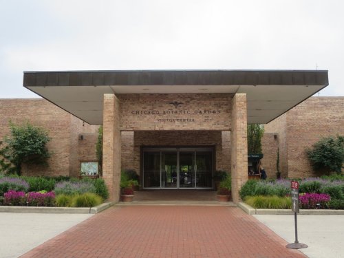 Entrance to the Chicago Botanic Garden Visitor Center, featuring brick architecture and colorful landscaping.