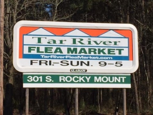 Sign for Tar River Flea Market, open Friday to Sunday, 9 AM to 5 PM, located at 301 S. Rocky Mount.