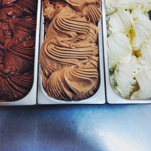 Three trays of gelato: rich chocolate, creamy hazelnut, and smooth vanilla, all beautifully swirled.