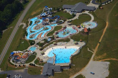 Aerial view of a large water park featuring pools, slides, and numerous visitors enjoying the attractions.