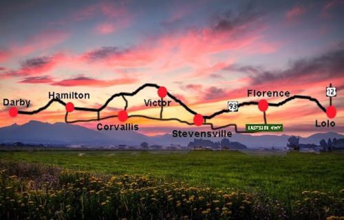 A scenic landscape with a highway map overlay showing towns like Darby, Hamilton, and Lolo against a sunset backdrop.