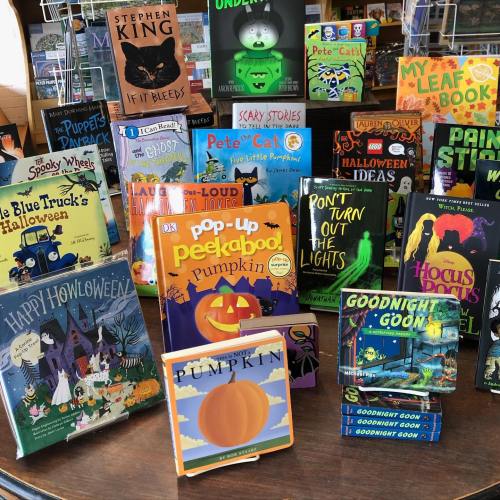 A colorful display of children's Halloween-themed books, featuring titles like "Pop-Up Peekaboo! Pumpkin" and "Goodnight Goon."
