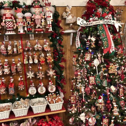 A festive display of Christmas ornaments and a decorated tree with a "Sugar and Spice" ribbon.