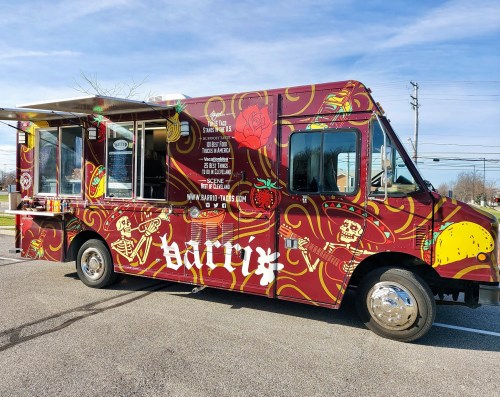 A colorful food truck with a vibrant design, featuring various food items and the name "Barry" prominently displayed.