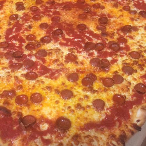 A close-up of a pepperoni pizza with melted cheese and a rich tomato sauce.
