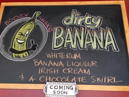 Chalkboard menu featuring a "Dirty Banana" boozy shake with ingredients: whiterum, banana liqueur, Irish cream, and chocolate swirl.
