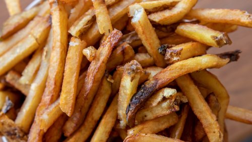 A close-up of golden-brown, crispy French fries piled together.