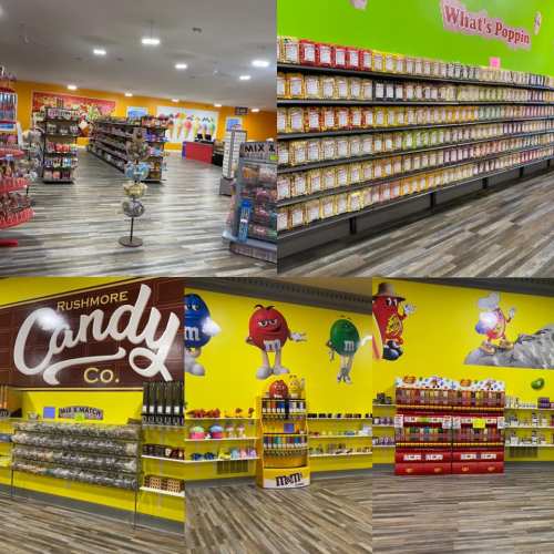 Bright candy store interior featuring colorful shelves filled with various candies and snacks, including M&M's and popcorn.