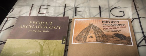 Two books on archaeology: one titled "Project Archaeology" and another with a cover featuring a Great Basin wickiup illustration.