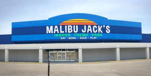 Sign for Malibu Jack's Indoor Theme Park, featuring activities like eating, bowling, racing, and playing.