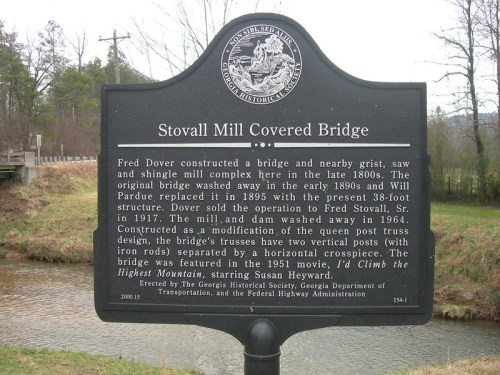 Historical marker about Stovall Mill Covered Bridge, detailing its construction and significance in Georgia.