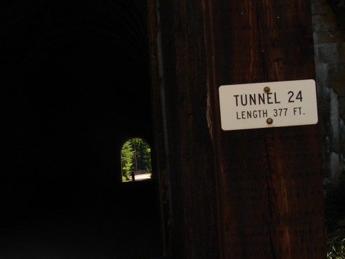 Sign for Tunnel 24, indicating a length of 377 feet, with a dark tunnel entrance in the background.