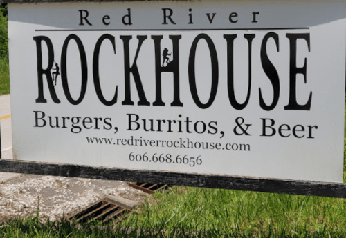 Sign for Red River Rockhouse featuring "Burgers, Burritos, & Beer" with contact information and website.