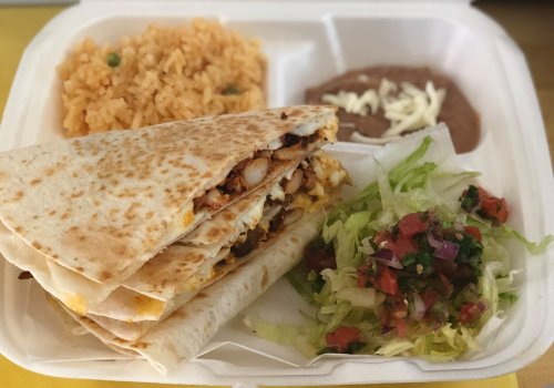 A takeout container with a quesadilla, rice, refried beans, and a side salad with lettuce and pico de gallo.