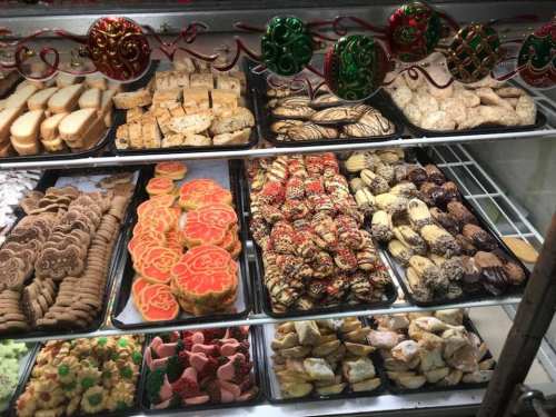 A display of assorted cookies and baked goods, including decorated cookies, pastries, and sweet treats.