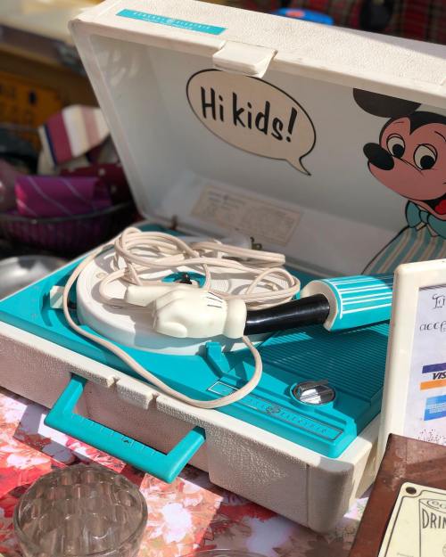 A vintage record player in a light blue case with a cartoon character and the text "Hi kids!" on the lid.
