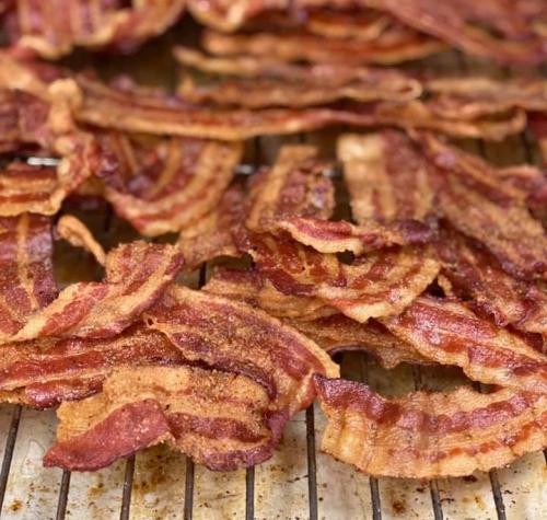 Crispy, golden-brown bacon strips arranged on a cooling rack.