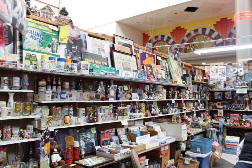 A vibrant display of various collectibles and memorabilia on shelves in a colorful store.