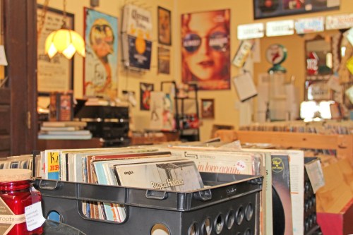 A cozy vintage record store filled with vinyl records, posters, and nostalgic decor.