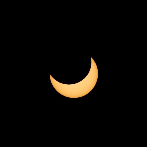 A crescent moon glowing against a dark sky, showcasing its bright, golden hue.