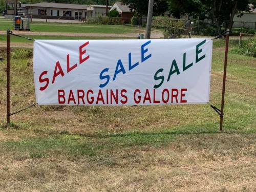 A large banner displaying "SALE SALE SALE" in red, blue, and green, with "BARGAINS GALORE" in bold red letters.