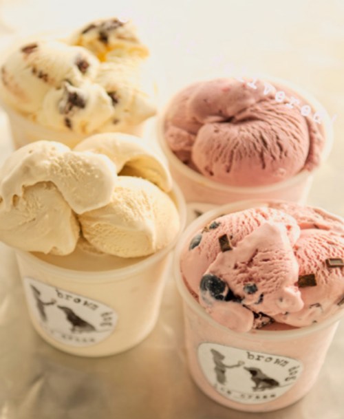 Four cups of ice cream in various flavors: vanilla, chocolate chip, strawberry, and a pink berry mix.