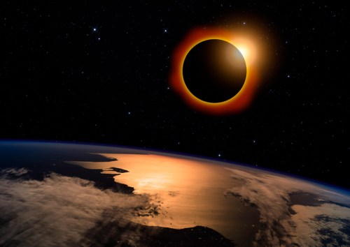 A solar eclipse viewed from space, with Earth below reflecting sunlight and stars scattered in the background.