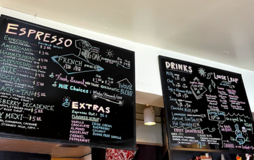Chalkboard menu featuring espresso drinks, loose leaf teas, and extras with prices listed. Colorful and artistic design.
