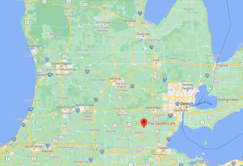 Map showing southeastern Michigan with a red marker indicating the location of Tea Garden Cafe near Adrian.