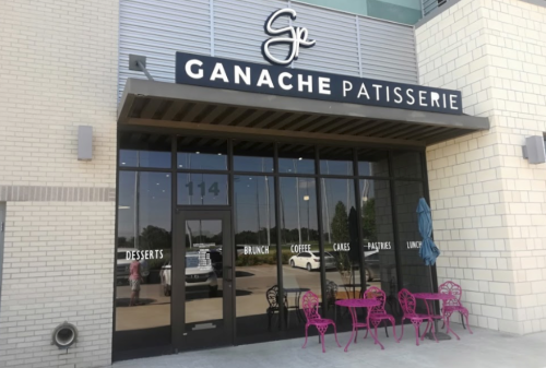 Exterior of Ganache Patisserie featuring a modern entrance with pink chairs and a menu of desserts, brunch, and coffee.