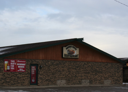 Exterior of Norway House Restaurant with a wooden facade and signage, featuring Budweiser advertisements.