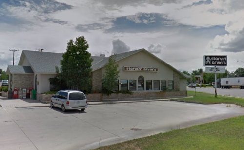 A restaurant named "Starvin' Arvin's" with a parking lot and a cloudy sky in the background.