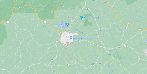 Map showing a region with roads, landmarks, and a highlighted area around a town center.