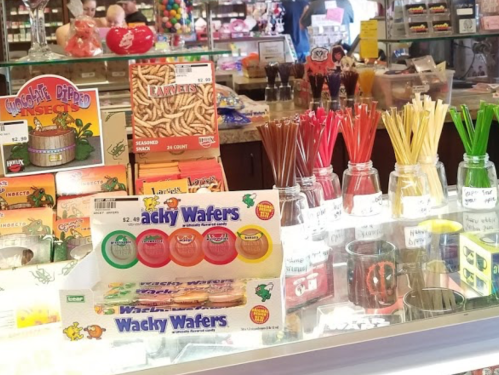 A colorful display of candy and snacks, including Wacky Wafers, jars of treats, and various novelty items.