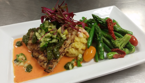 Grilled fish topped with salsa, served with risotto and a side of sautéed asparagus and green beans.