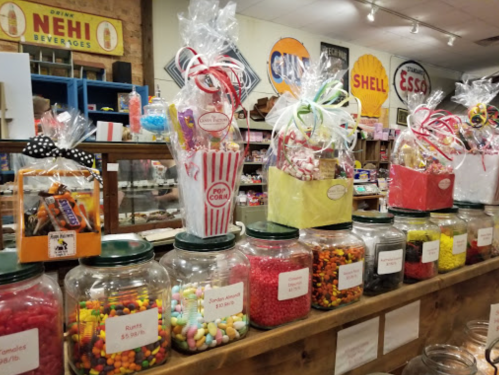 A colorful display of candy jars and gift baskets in a vintage candy shop.