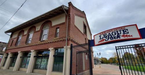 Historic League Park building in Cleveland, featuring brick architecture and a welcoming entrance sign.