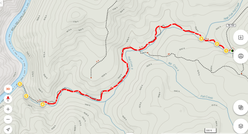 Map showing a winding trail marked in red along a river, with contour lines and elevation points indicated.