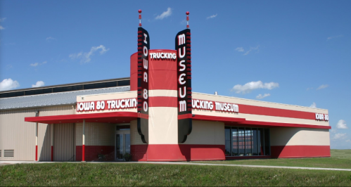 Exterior of the Iowa 80 Trucking Museum, featuring a retro design with red and white colors against a blue sky.