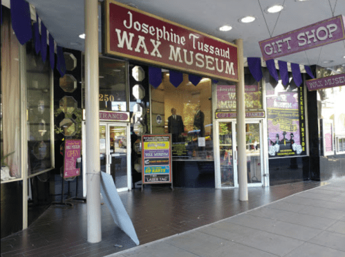 Entrance to Josephine Tussaud Wax Museum, featuring a gift shop and colorful signage.