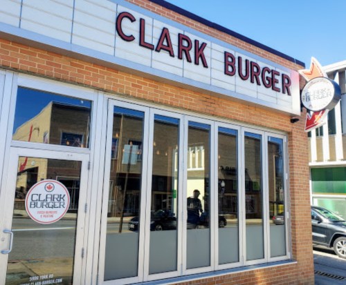 Exterior of Clark Burger restaurant with large windows and a sign featuring the restaurant's name.