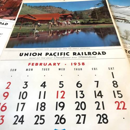 A vintage calendar page for February 1958 featuring a scenic ranch and a reflection in water. Union Pacific Railroad logo visible.