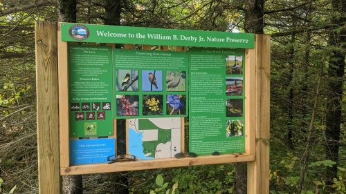 Sign at William B. Derby Jr. Nature Preserve, detailing rules, habitat preservation, and local wildlife information.