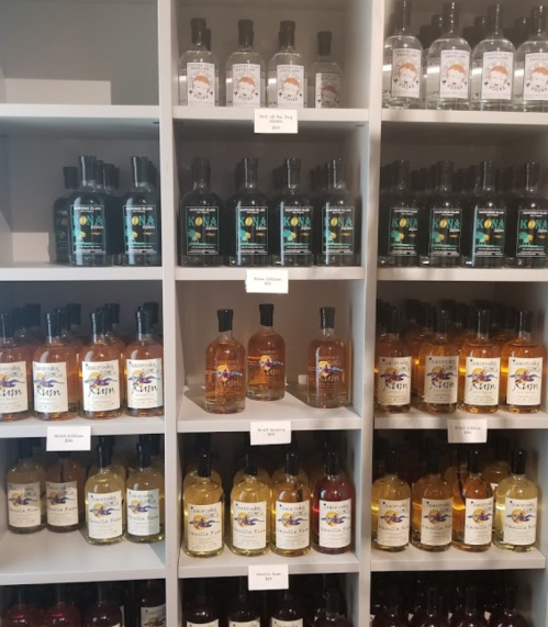 A display of various bottles of liquor arranged on shelves, labeled with different brands and types.