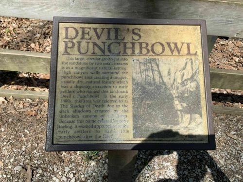 Sign describing Devil's Punchbowl, highlighting its natural beauty and historical significance to early settlers.