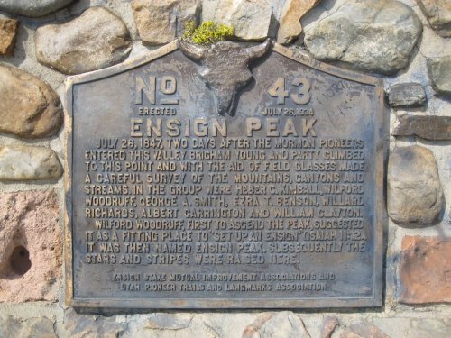 A stone plaque marking Ensign Peak, detailing its historical significance and the date of its erection.