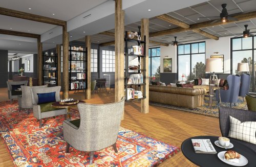 Cozy lounge with wooden beams, bookshelves, comfortable seating, and large windows, featuring a chess set and coffee.
