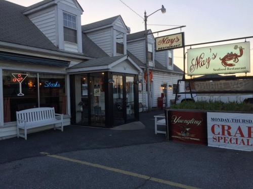 Exterior of May's Seafood Restaurant, featuring a sign, outdoor seating, and a welcoming entrance.