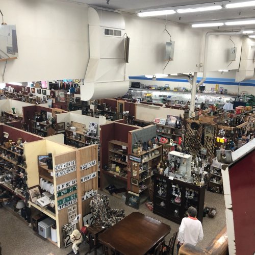 Aerial view of a large antique store filled with various items, displays, and shoppers exploring the aisles.