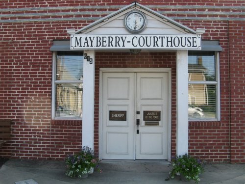 Front view of the Mayberry Courthouse, featuring a clock, double doors labeled "Sheriff" and "Justice of the Peace."